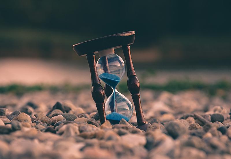 hourglass on river rock