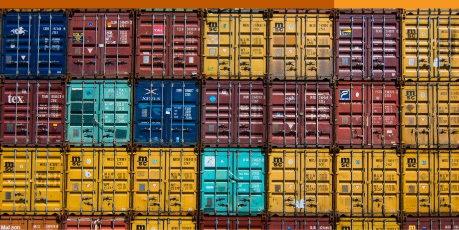 Stacks of shipping containers side-by-side in various colors.