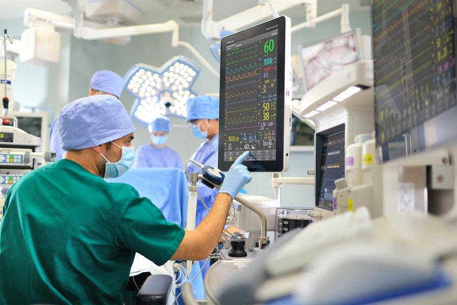 surgical team in operating room monitoring patient stats