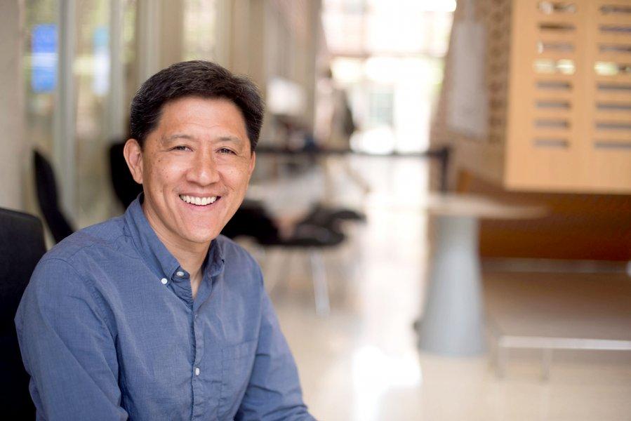 Calvin Lin sitting in a chair in the GDC atrium