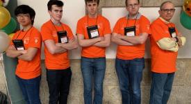 ICPC competitors from UT stand together as a group at the competition