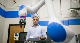 Dr. Chetan Kapoor with a dual-arm, SDA10F robot