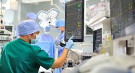 surgical team in operating room monitoring patient stats
