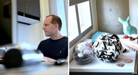 Etienne Vouga sitting at his desk in his office at GDC, wearing a black t-shirt and facing his computer.