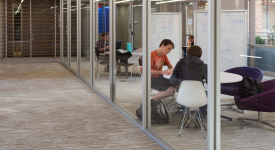 Students studying on the 3rd floor atrium bridge with Computing Across Disci