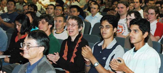 Audience reacting to Professor Cline&#039;s speech, Professor Lam, front left