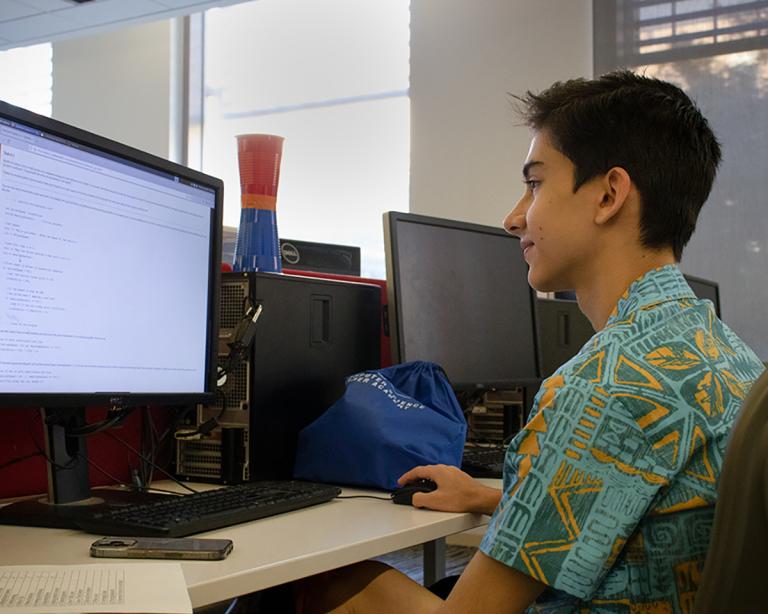 Academy for All student learning code in the UT Computer Science computer lab