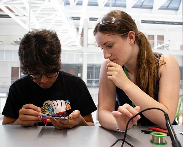 Students working together on building a robot in the robotics lab on UT Campus